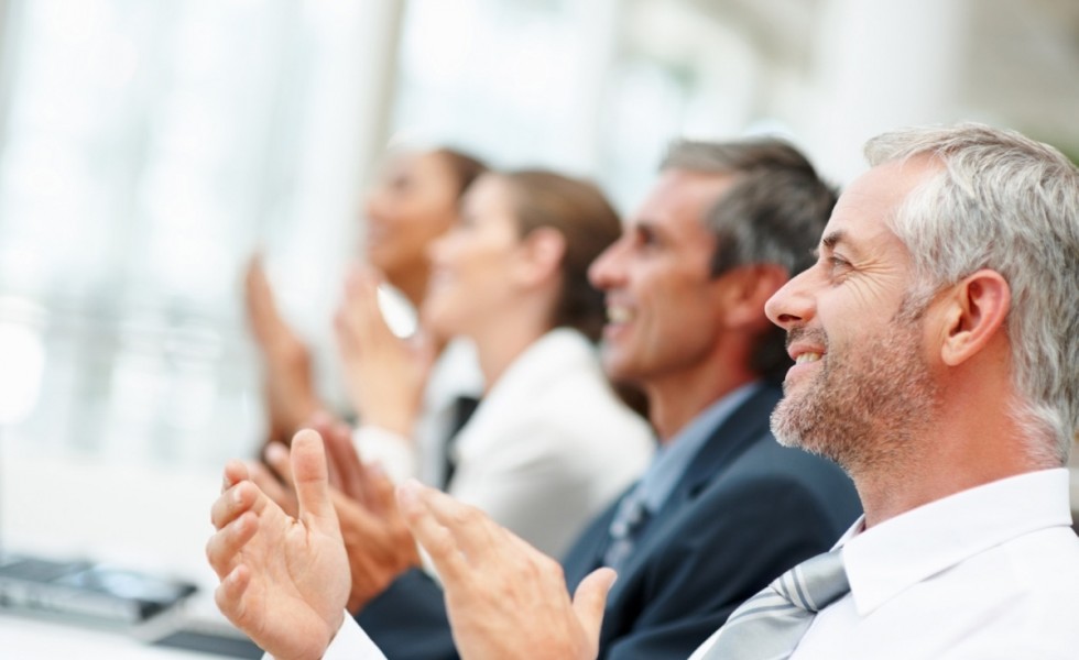 Group of happy business people clapping their hands