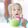 Adorable little girl eating ice cream at summer