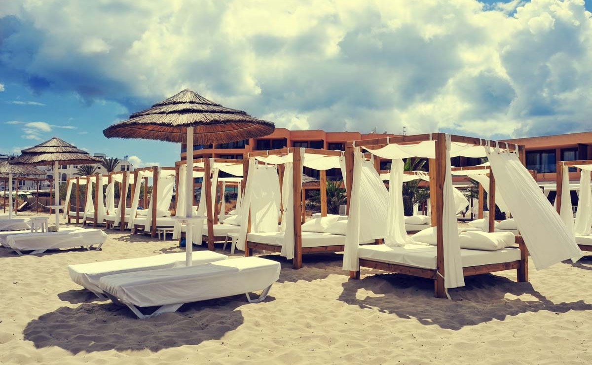 beds and sunloungers in a beach club in Ibiza, Spain