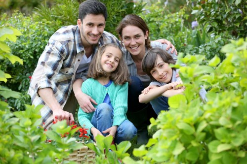 Portrait of happy family gardening together