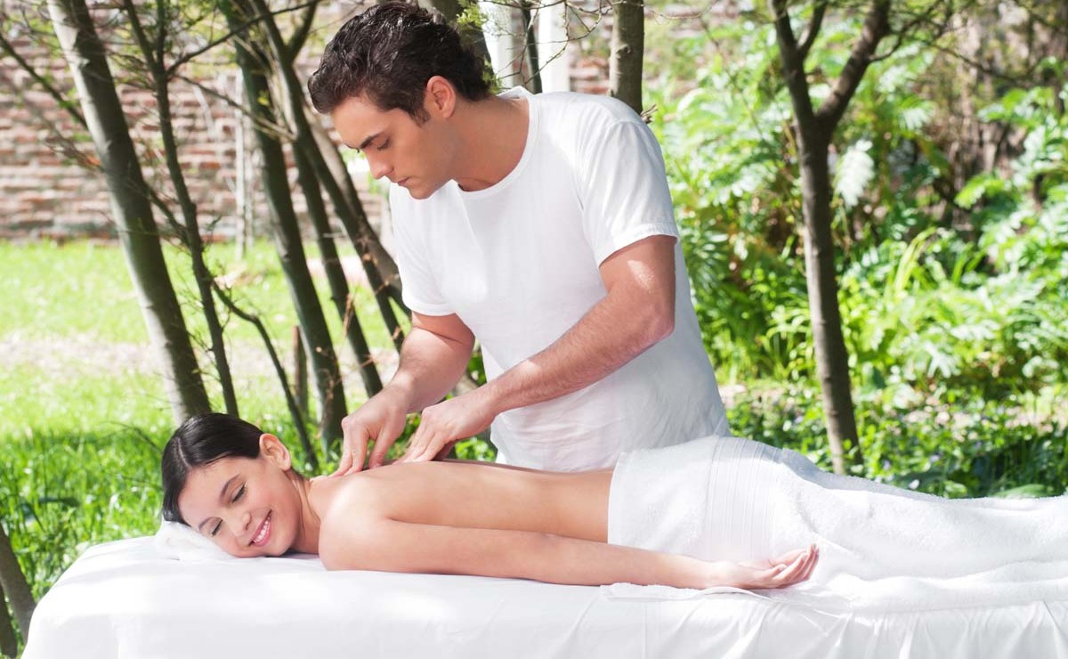 Young woman getting a massage by a handsome man